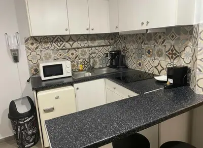 a kitchen with a sink and a microwave on a counter at The Athenian Nest 2-Bedroom Apartment in Metaxou in Athens