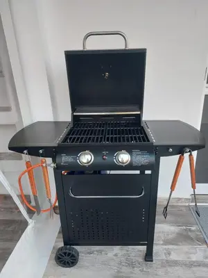 a black grill with a laptop on top of it at Saroné Villa in Anavissos