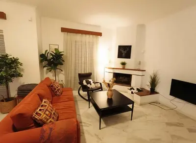 a living room with a couch and a fireplace at Athenas Residence 3-Bedroom Apartment in Alimos in Athens