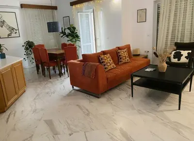 a living room with a couch and a table at Athenas Residence 3-Bedroom Apartment in Alimos in Athens