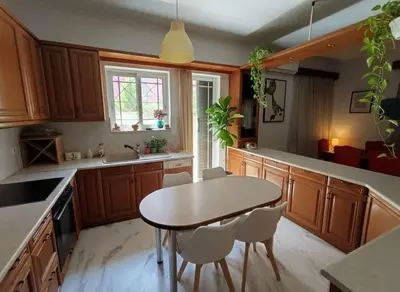 a kitchen with a wooden table and chairs and a table at Athenas Residence 3-Bedroom Apartment in Alimos in Athens