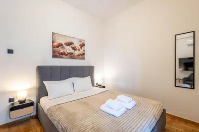 a bedroom with a bed with two towels on it at Acropolis Canvas-3BDR in Athens