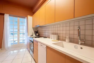 a kitchen with a sink and a window at Acropolis Canvas-3BDR in Athens