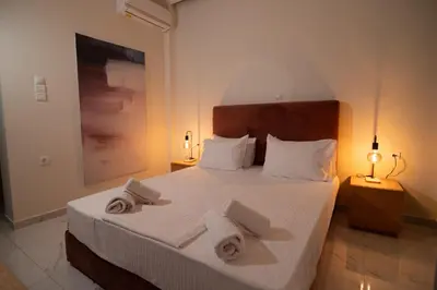 a bedroom with a bed with towels on it at Monza in Athens