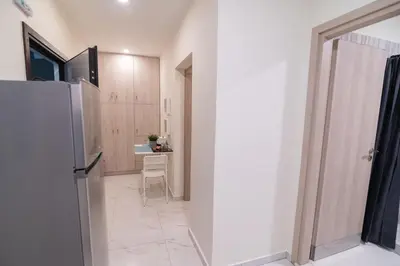 a small kitchen with a refrigerator and a table at Monza in Athens