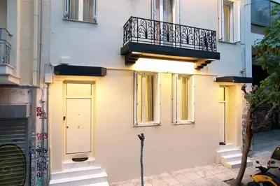 a building with a balcony and a door at Monza in Athens