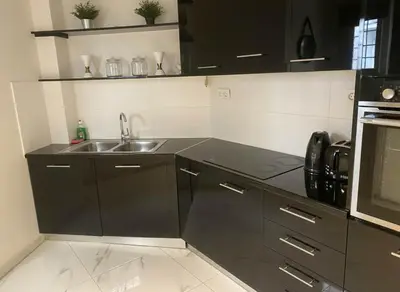 a kitchen with a sink and a stove top oven at Cozy 1-Bedroom Apartment in Pagkrati Close to Metro in Athens