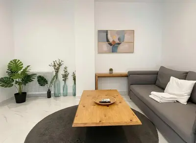 a living room with a couch and a coffee table at Cozy 1-Bedroom Apartment in Pagkrati Close to Metro in Athens