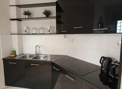 a kitchen with a sink and a counter top at Cozy 1-Bedroom Apartment in Pagkrati Close to Metro in Athens