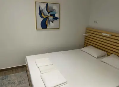 a bed in a room with a picture on the wall at Athens at Your Doorstep Chic Syntagma Apartment in Athens