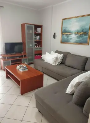 a living room with a couch and a coffee table at Urban Comfort Stay in Peristeri in Athens