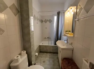 a bathroom with a toilet and a sink and a tub at Urban Comfort Stay in Peristeri in Athens