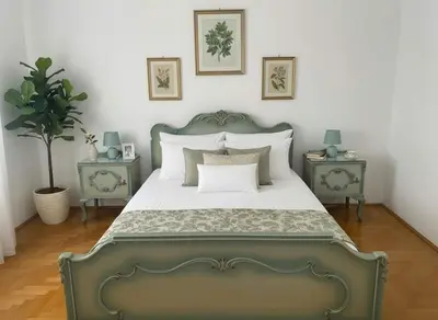 a bedroom with a green bed with two end tables at Family-Friendly Comfort in the Heart of Koukaki in Athens
