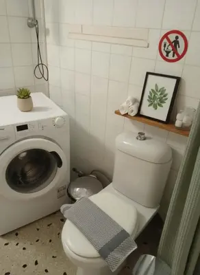 a bathroom with a toilet and a washing machine at Family-Friendly Comfort in the Heart of Koukaki in Athens