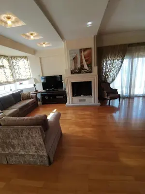 a living room with a couch and a fireplace at Luxurious maisonette 4 metro stops to Acropolis in Athens