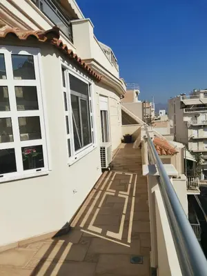 a balcony of a house with white walls and windows at Luxurious maisonette 4 metro stops to Acropolis in Athens