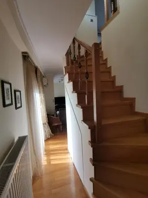 a stairway in a home with a wooden staircase at Luxurious maisonette 4 metro stops to Acropolis in Athens