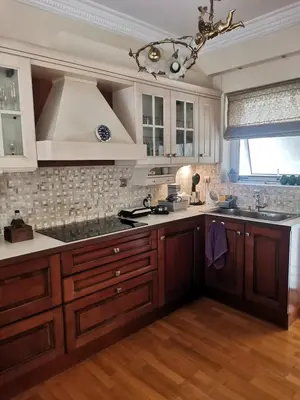 a kitchen with wooden cabinets and a large kitchen island at Luxurious maisonette 4 metro stops to Acropolis in Athens