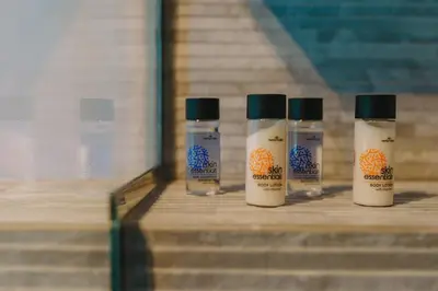 three bottles sitting on top of a wooden table at Modern 2BR Apt Glyfada Center and Private Veranda in Athens