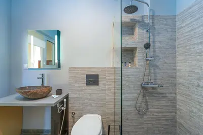 a bathroom with a shower with a toilet and a sink at Modern 2BR Apt Glyfada Center and Private Veranda in Athens