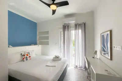 a bedroom with two beds and a ceiling fan at Stylish Home in Petralona in Athens
