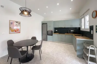 a kitchen with a table and chairs in a room at Stylish Home in Petralona in Athens