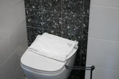 a white towel is sitting on top of a toilet at Stylish Home in Petralona in Athens