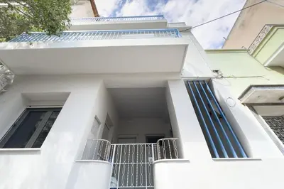 a white facade of a house with stairs at Stylish Home in Petralona in Athens