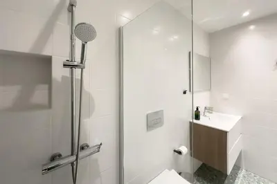a bathroom with a shower and a toilet and a sink at Stylish Home in Petralona in Athens