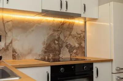 a kitchen with a counter top with a dirty wall at Krisila Boutique Stay in Athens