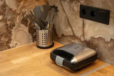 a toaster sitting on a table with a cup of utensils at Krisila Boutique Stay in Athens