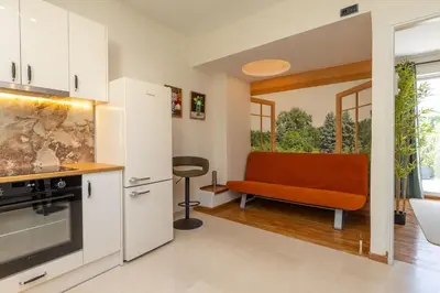 a kitchen with an orange couch in a room at Krisila Boutique Stay in Athens