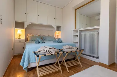 a bedroom with a bed and a table with towels on it at Krisila Boutique Stay in Athens