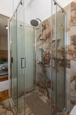 a shower with a glass door in a bathroom at Krisila Boutique Stay in Athens