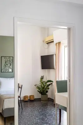 a bedroom with a bed and a table and a desk at Athens Nala in Athens