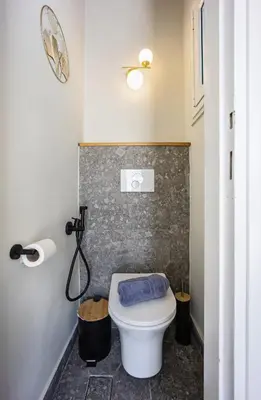 a bathroom with a toilet with a blue towel on it at Athens Nala in Athens