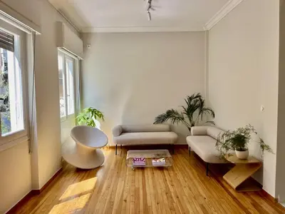a living room with a couch and a table at Athens Classic 2- Bedroom Apartment in Athens