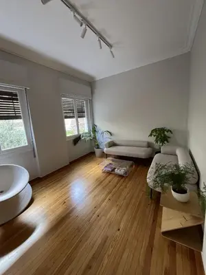 an empty living room with two potted plants at Athens Classic 2- Bedroom Apartment in Athens