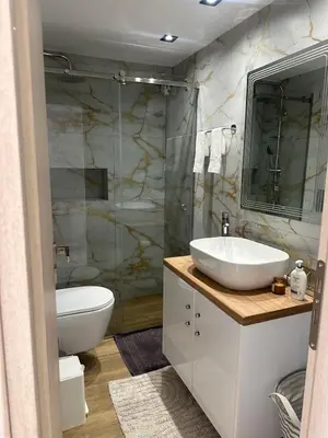 a bathroom with a sink and a toilet and a shower at Cozy, Quiet & Modern Apartment in Athens