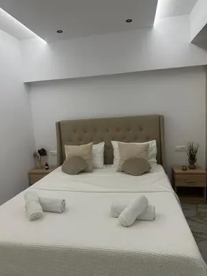 a large white bed with two pillows on it at Cozy, Quiet & Modern Apartment in Athens