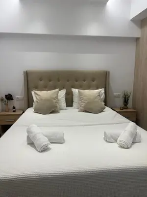 a large white bed with two pillows on it at Cozy, Quiet & Modern Apartment in Athens
