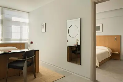 a bedroom with a desk and a bed with a mirror at P28 Suite 103 in Athens