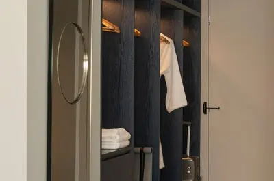 a bathroom with a mirror and a closet with towels at P28 Suite 103 in Athens