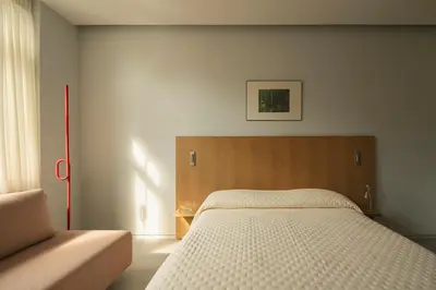 a bedroom with a large bed and a couch at P28 Suite 104 in Athens
