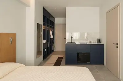 a bedroom with a bed and a sink and a bathroom at P28 Suite 104 in Athens