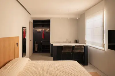 a bedroom with a bed and a kitchen with a counter at P28 Suite 109 in Athens