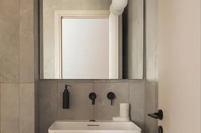 a bathroom with a white sink and a mirror at P28 Suite 109 in Athens