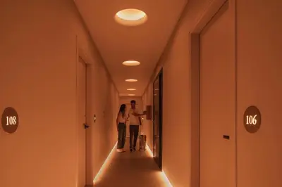 a man and a woman walking down a hallway at P28 Suite 109 in Athens