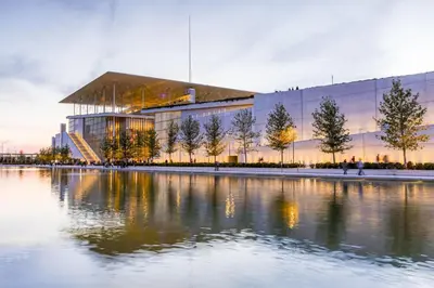 a large building with a lake in front of it at Relaxing Flat by Stavros Niarchos Park in Athens