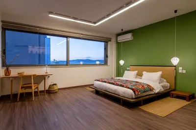 a bedroom with green walls and a bed and a desk at Athens Heart Urban Zen Loft in Athens
